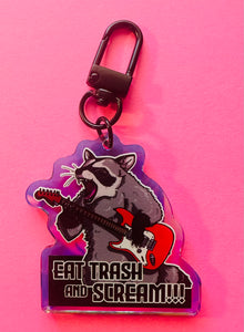 “Eat trash and SCREAM!” Raccoon with guitar Rainbow Holographic Keychain!